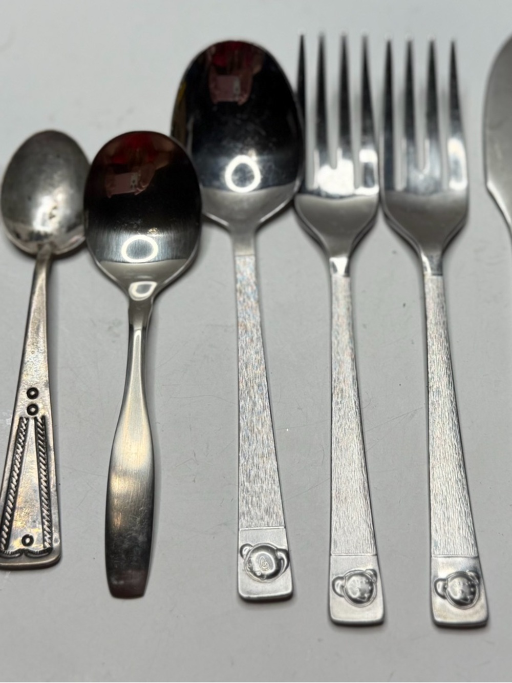 a selection of vintage cutlery, including children's sets